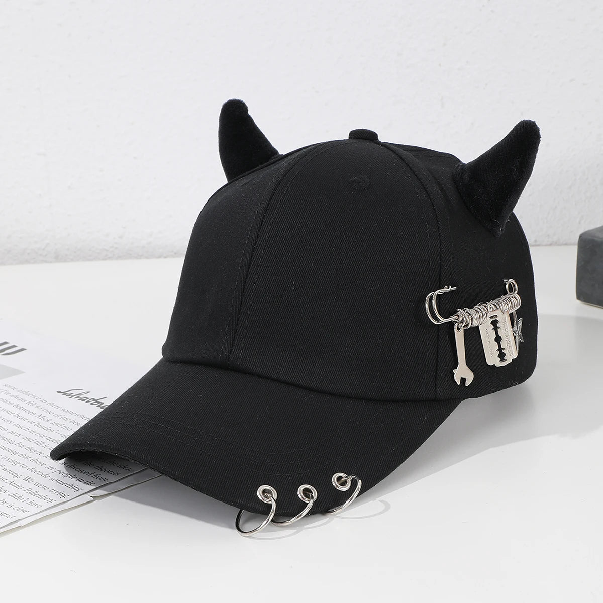 Modebroche i metal i form af en hoop, dekoreret i hiphop-stil, med hornmotiv, baseballkasket, udendørs, afslappet og sjov hat